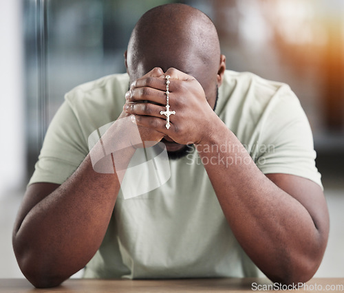 Image of Prayer, rosary and hands of black man for worship, faith and belief for support, help and hope. Religion, praying and christian person in home for meditation, spiritual healing and trust for praise