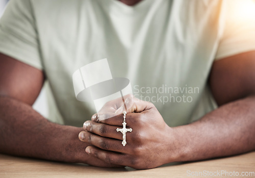 Image of Crucifix cross, man hands and prayer beads in home with faith, christian praise and religion. Praying, necklace and worship in house with hope, gratitude and spiritual guide for support and healing