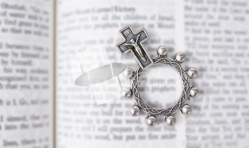 Image of Rosary, open book or bible study for worship, religion or mindfulness with holy spiritual scripture. Christian literature, background or history education or knowkedge guide on God or Jesus Christ