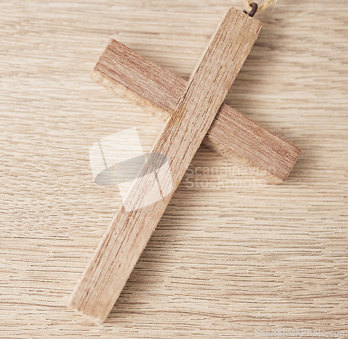 Image of Background, religion and closeup of wooden cross on table for worship to God, prayer and resurrection of Jesus Christ. Faith, christianity and crucifix sign for holy spirit, heaven or spiritual trust