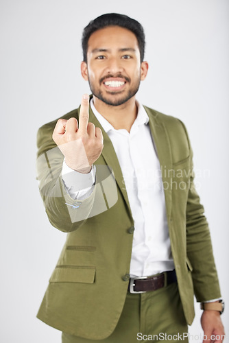 Image of Business man, middle finger and studio portrait with anger, rude and frustrated by white background. Indian entrepreneur, smile and emoji for sign language, vote and opinion with hand for conflict