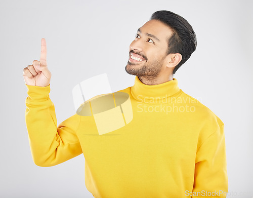 Image of Announcement, pointing and thinking man with promotion, deal and logo isolated in a studio white background with smile. Choice, ambassador and happy person showing advertising, news or notification