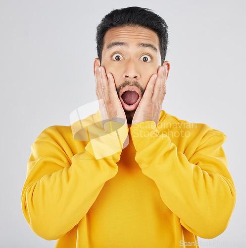 Image of Wow, news and hands on face of man in studio for omg, surprise or promo on white background. Wtf, emoji and portrait of Japanese guy model shocked by announcement, gossip info or coming soon sale