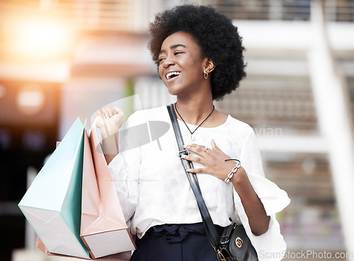 Image of Black woman, shopping bag and happy customer walking outdoor in a city for retail deal, sale or promotion. African person with gift, smile and excited about buying fashion product on urban travel
