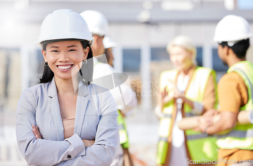 Image of Construction worker, architecture and Asian woman on engineering site with team or designers for property renovation. Portrait, professional and arms crossed of project leader for building inspection