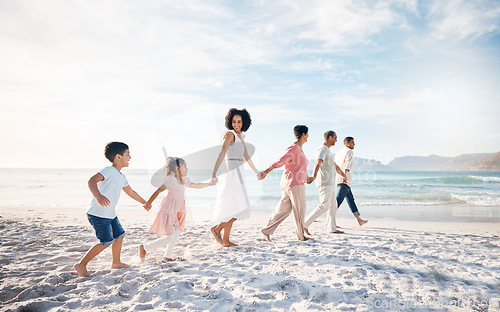 Image of Big family, holding hands and walking at the beach for travel, vacation and adventure in nature. Love, freedom and children with parents and grandparent at sea for fun, journey and bond ocean holiday