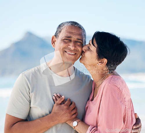 Image of Kiss, love and mature couple outdoor at beach with a smile, care and happiness together in nature. Portrait of a happy man and woman for healthy marriage, kindness and anniversary on a travel holiday