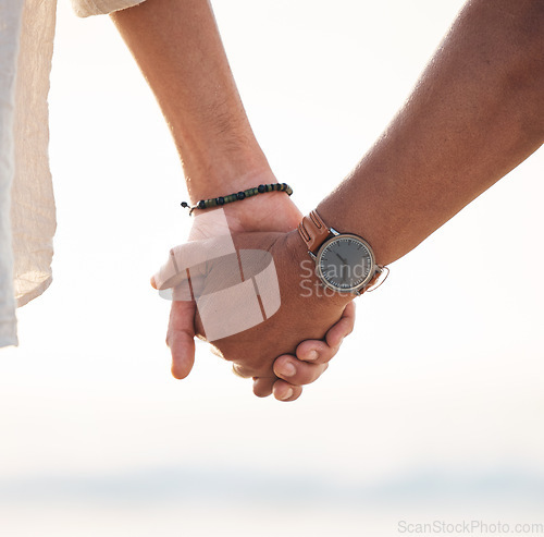 Image of Love, couple and holding hands at the beach for support, hope and solidarity on nature closeup. Zoom, unity and hand holding by man and woman outdoor with care, empathy and trust, kindness or help