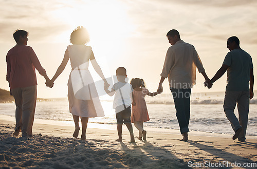 Image of Beach, sunset and back of family holding hands in nature for travel, bond and fun together. Rear view, love and children with parents, grandparents and walking at sunrise on holiday adventure