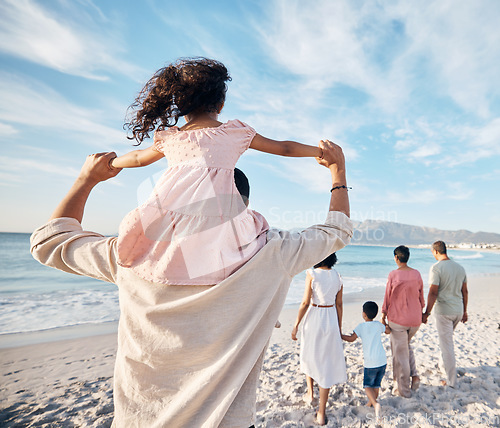 Image of Big family, holiday and walking on beach together, piggy back and holding hands on summer island sand from behind. Parents, grandparents and kids adventure on tropical vacation at ocean in Hawaii.