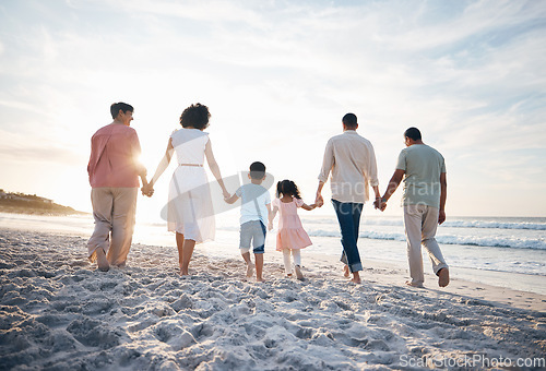 Image of Walking, holding hands and back of big family at the beach for travel, vacation and adventure in nature. Love, freedom and rear view of children with parents and grandparent at sea for ocean journey