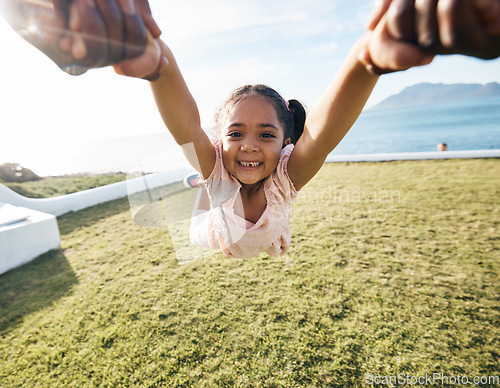 Image of Girl, spin and outdoor portrait in pov, holding hands or happy for game with parent, holiday or backyard. Female child, smile and swing in air, fast or excited for play on vacation in summer sunshine