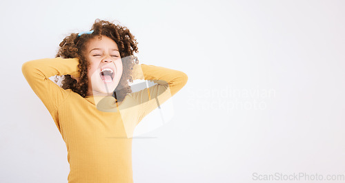 Image of Shouting, loud and mockup with a girl child in studio on a white background covering her ears. Children, sound and audio with a young kid screaming or yelling on empty space for ADHD or autism