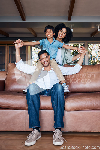 Image of Smile, airplane and portrait with family on sofa for happy, bonding or peace on holiday. Love, care and playful with parents and child in living room at home for vacation, cuddle and embrace together