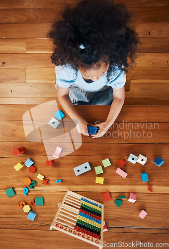 Image of Above, child and toys for learning on the floor, home education and fun activity. House, young and a girl kid with blocks and abacus for recreation, math or perspective on the ground in childhood