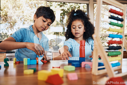 Image of Siblings, children and playing building blocks for development, learning and growth on table in kitchen. Family, boy and girl child with toys for education, math, numbers and creativity in house