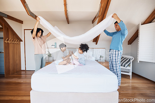 Image of Blanket, fort and children on bed with parents for fun, play or hand game in their home. Bedroom, cover and kids with mother and father waking up, happy and weekend, day off or family time in house