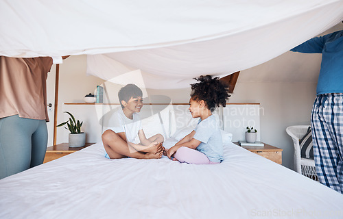 Image of Blanket, cover and children on bed with parents for fun, play or bond in their home. Bedroom, fort and kids with mother and father for morning games and enjoy weekend, day off or family care in house