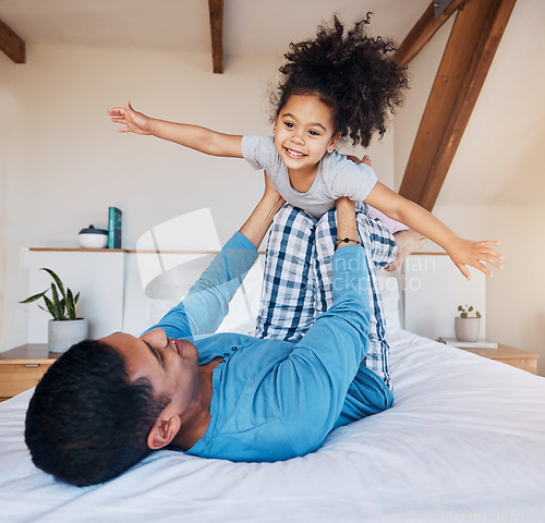 Image of Airplane, smile and girl child with father on bed flying for fun, fantasy, and happiness in modern apartment. Family, play and face of young kid with dad in bedroom for quality time and bonding