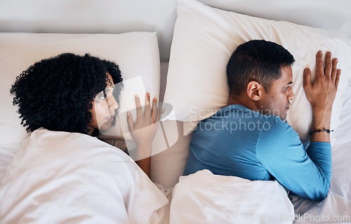 Image of Frustrated couple, fight and lying in bed conflict, divorce or argument from disagreement or dispute at home. Top view of woman and man in breakup, cheating affair or toxic relationship in bedroom