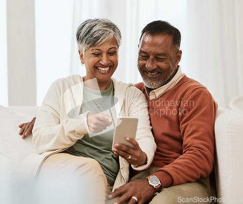 Image of Phone, relax and mature couple on a home sofa for search, internet and social media. Happy man and woman laugh together on couch with a smartphone for funny meme, online communication app or website