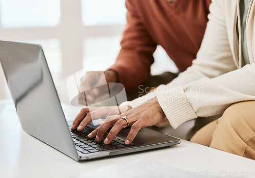 Image of Hands, closeup and a couple with a laptop for internet, connection or research. Table, home and people typing on a computer for mortgage information, email or together for a movie online on a pc
