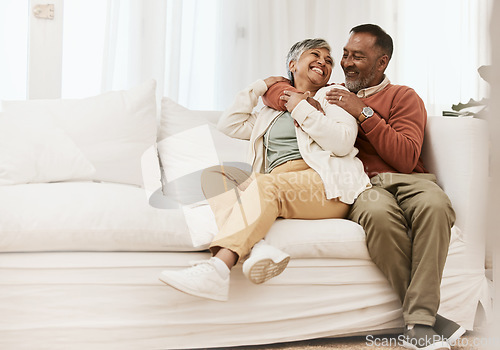 Image of Happy, laugh and senior couple hug on sofa with conversation, care and romance in their home. Smile, embrace and elderly man with woman in living room relax, talking and enjoying retirement in house