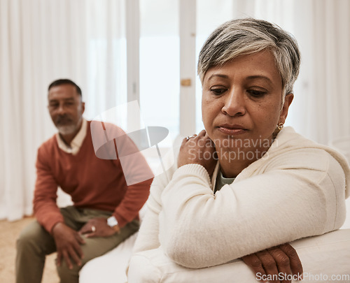 Image of Senior, frustrated and couple in fight, conflict or argument in divorce, dispute or disagreement on sofa. Mature man and woman in toxic relationship, marriage or breakup from cheating affair at home