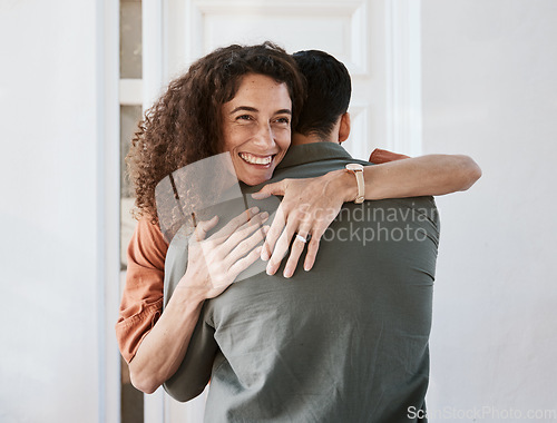 Image of Happy, love and a couple hugging in their home for support, care or romance in marriage together. Smile, trust and security with a woman embracing her husband in their house for relationship bonding