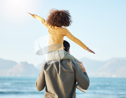 Image of Piggyback, kid and father at beach view on vacation, holiday and bonding on mockup space. Dad, play and carrying child at ocean, having fun and family travel to sea together in support, care or love