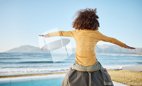 Image of Father, child on shoulders and freedom at beach, bonding and piggyback, fun and games with back view. Man, young girl and playing, summer and care, love and adventure with parenting and childhood