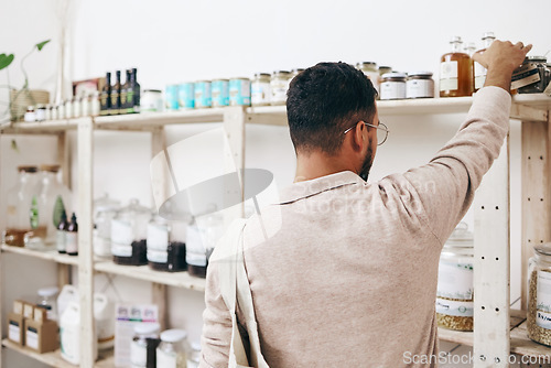 Image of Customer, back and shopping by shelf in grocery store for healthy food, nutrition and wellness product sales. Choice, decision and nutritionist man in supermarket for retail purchase, buying or deal