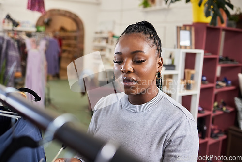 Image of Shopping, woman and clothes rail for fashion at a retail store with sale or discount. A black person or customer in a shop for product choice, promotion or designer brand in a boutique or mall