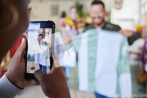 Image of Fashion, phone and man taking a picture for shopping in a retail store for social media influencer. Style, cellphone and male content creator posing with clothes for an outfit for brand ambassador.