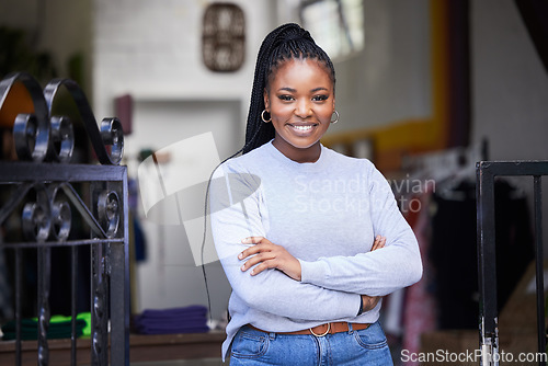 Image of Happy black woman, portrait and arms crossed in clothes store, thrift shop or fashion workshop in owner pride. Smile, confident and professional designer in small business or retail donation industry