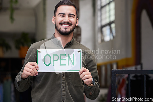 Image of Open, sign and happy business owner working in retail, store or start of service in restaurant, cafe or coffee shop. Portugal, startup and opening with a welcome, poster or smile for portrait