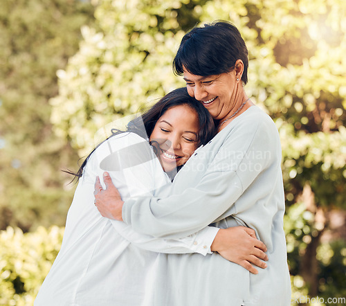 Image of Mature woman, daughter and hug in garden with love on mothers day or women bonding with care for mom in retirement. Happy, family and embrace outdoor, backyard or together on holiday or vacation