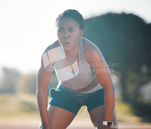 Image of Break, tired and a black woman at a stadium for a workout, training or breathing after cardio. Sports, race and an athlete or African runner with an idea for fitness, running or exercise on a track