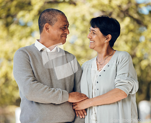 Image of Mature couple in park, love and smile, support and trust with bonding and marriage. Life partner, retirement together and romance, people are happy outdoor with healthy relationship and care