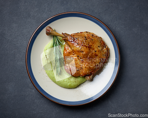 Image of duck leg confit and broccoli puree