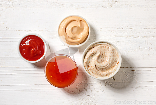 Image of various sauces on white wooden table