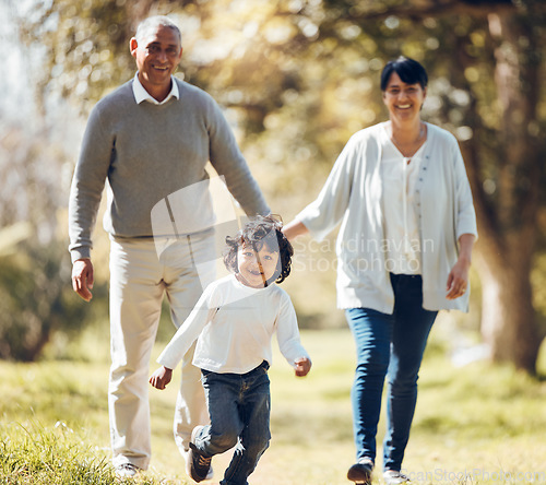 Image of Happy, running and grandparents with child in park for playing, love and support. Care, smile and freedom with family walking on nature path for peace, summer vacation and happiness together