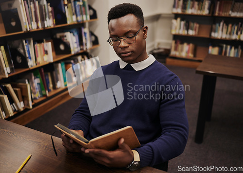 Image of University, book and black man student reading and learning in a college for knowledge development. Serious, education and person studying research to prepare for exam or assignment in a class