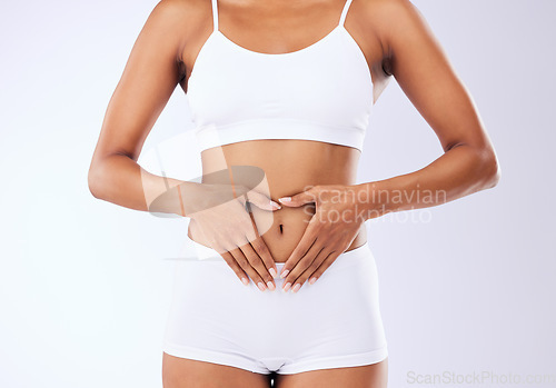 Image of Stomach, heart hands and woman on a white background for love of fitness, body balance and digestion. Diet, underwear and girl with a gesture for gut health, stomach and medical wellness support