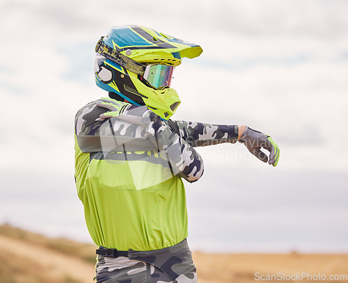 Image of Motor sports, stretching and man with helmet in nature for training, workout and performance for race. Travel, motorbike and person outdoors ready for action for adventure, freedom and adrenaline