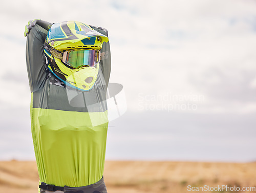 Image of Sports, stretching and man with helmet in nature for training, workout and performance. Travel, mockup space and person outdoors for motor cycling for adventure, freedom and adrenaline in desert