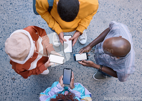 Image of Friends, circle and phone in top view, outdoor and texting on social media, app and web communication. Group, gen z students or people with smartphone, internet and contact in urban street in city