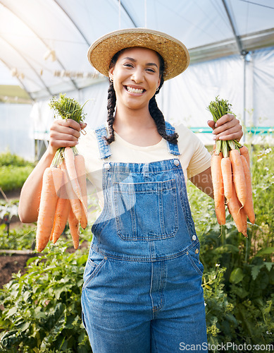 Image of Farming, portrait of woman with carrots and smile at sustainable small business, agriculture and natural food. Girl working at happy agro greenhouse, vegetable growth in garden and eco friendly pride