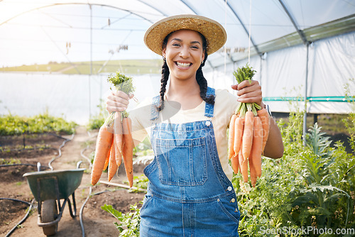 Image of Farming, portrait of happy woman holding carrots at sustainable small business in agriculture and natural organic food. Girl working at agro greenhouse, vegetable growth and eco friendly with smile.