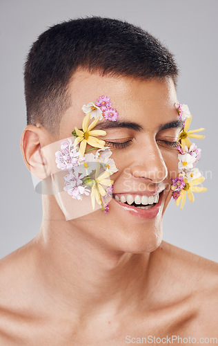 Image of Cosmetics, man and eyes closed, flower pattern on face and skincare in studio for aesthetic, decoration and beauty on gray background. Smile, closeup and person with floral art for carnation and glow